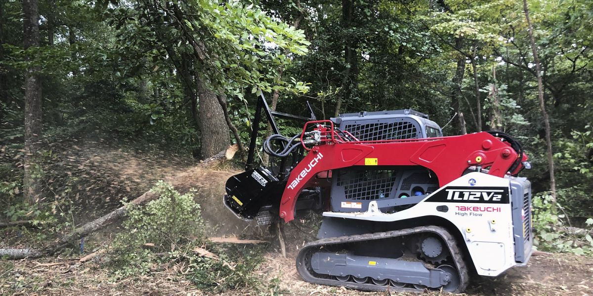 A Forestry Cleanup Truck By A Tree Stump Removal Company Is Clearing The Trees And Tree Debris From A Dense Forested Area