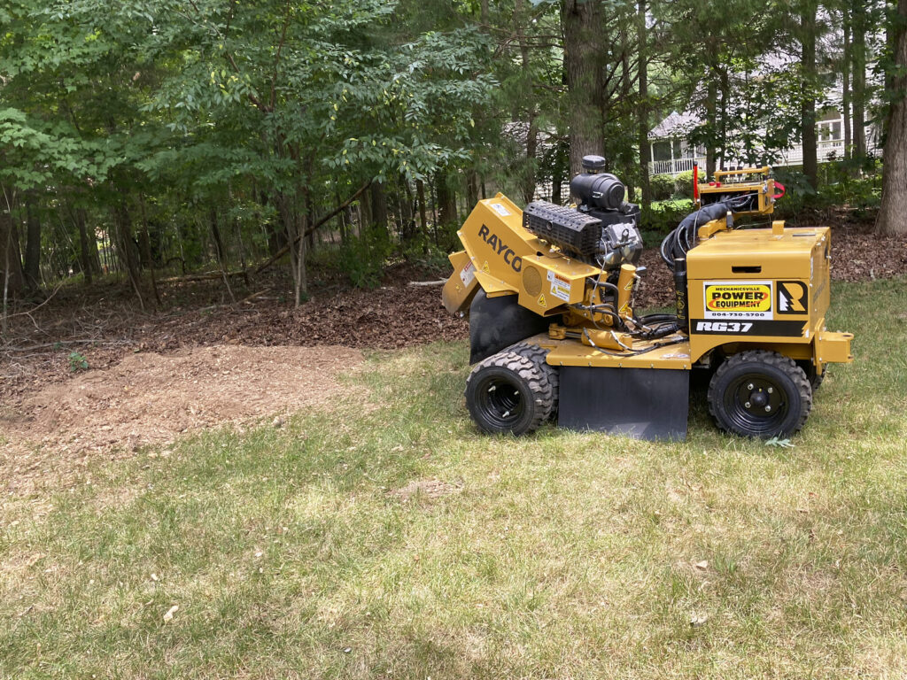 A Stump Grinding Machine In A Field Used By A Tree Stump Removal Company For Tree Stump Removal Services