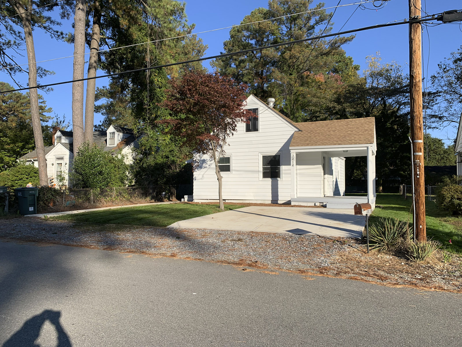 Wide Angle Shot Of A Road Corner House With A Small Lawn Covered With Several Grass Turfs After Sod Installation Service